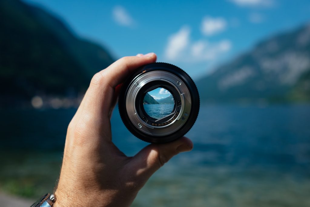 Someone Holding a camera Lense